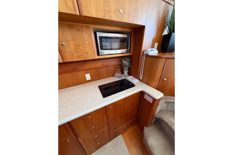 Slide: The Image of 2001 Silverton 42 Convertible yacht kitchen with microwave and stovetop. - 37
