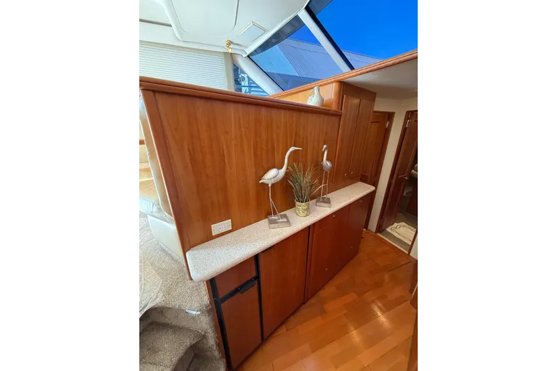 Slide: The Image of Interior of 2001 Silverton 42 Convertible yacht with wooden cabinetry and decorative accents. - 38