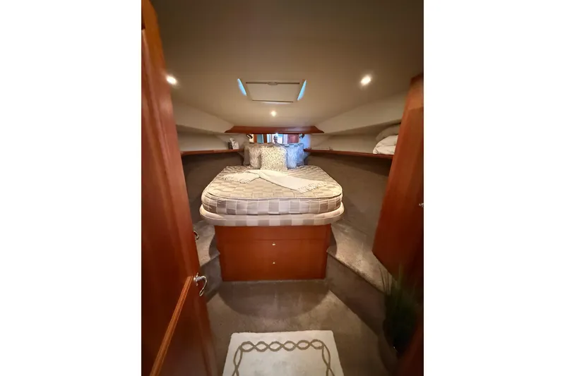 Slide: The Image of Luxurious cabin interior of a 2001 Silverton 42 Convertible yacht with cozy bedding. - 39