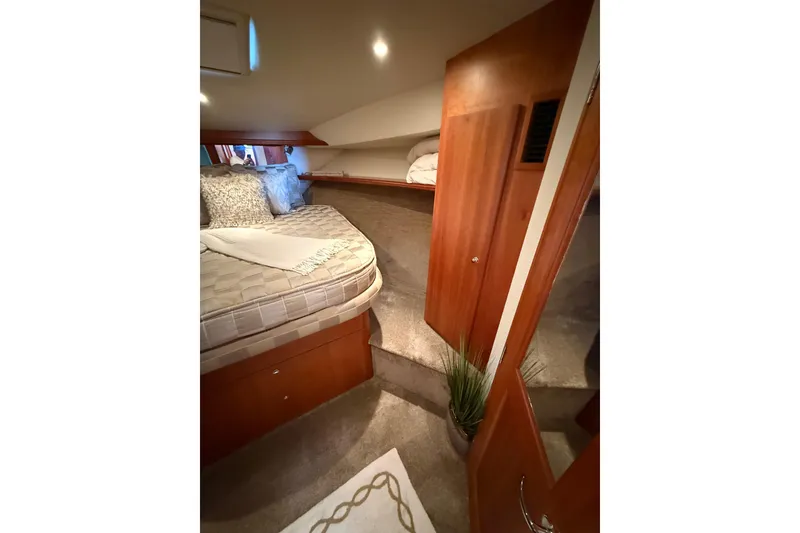 Slide: The Image of Interior cabin of 2001 Silverton 42 Convertible yacht with cozy bed and wooden accents. - 40