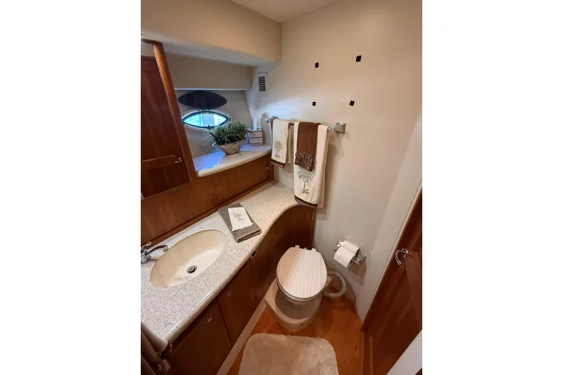 Slide: The Image of Bathroom interior of 2001 Silverton 42 Convertible yacht, featuring sink and toilet. - 43