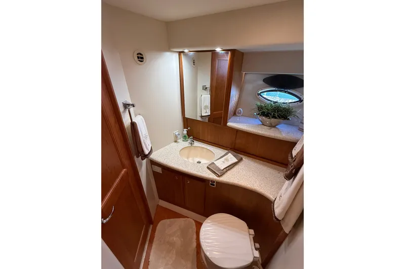 Slide: The Image of Luxurious bathroom in 2001 Silverton 42 Convertible yacht with elegant wood cabinetry. - 44