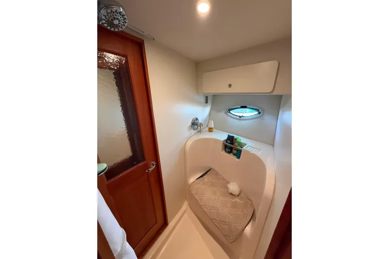 Slide: The Image of Bathroom interior of 2001 Silverton 42 Convertible yacht with shower and porthole. - 45
