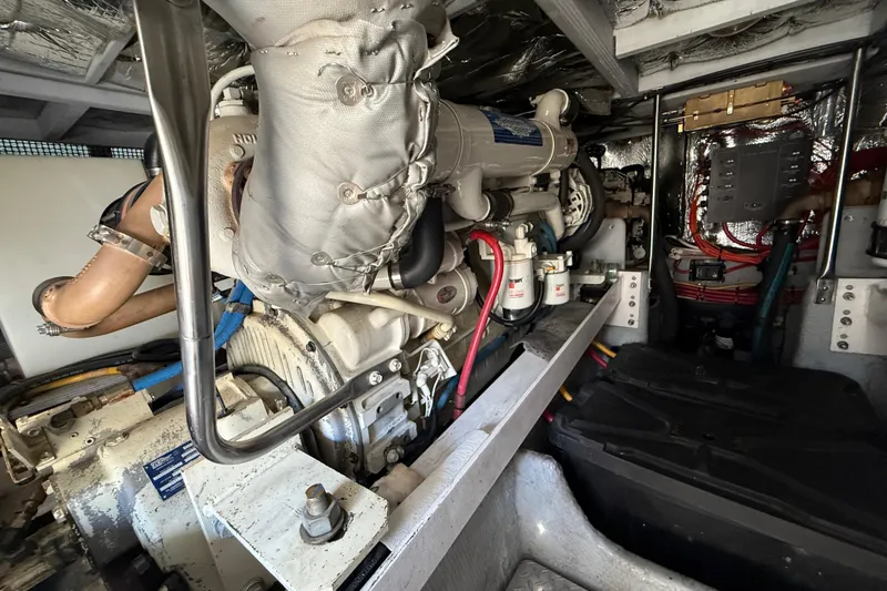 Slide: The Image of Engine room of a 2001 Silverton 42 Convertible yacht, showcasing mechanical components and wiring. - 48