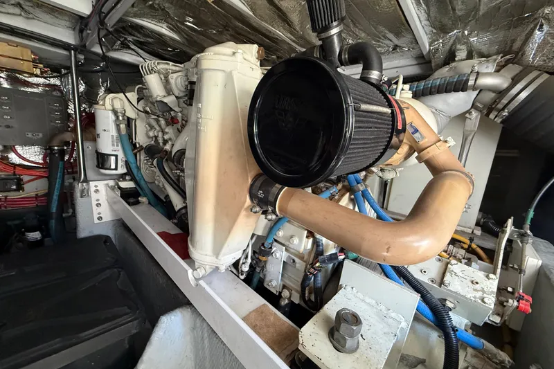 Slide: The Image of Engine room of a 2001 Silverton 42 Convertible yacht, showcasing mechanical components. - 49