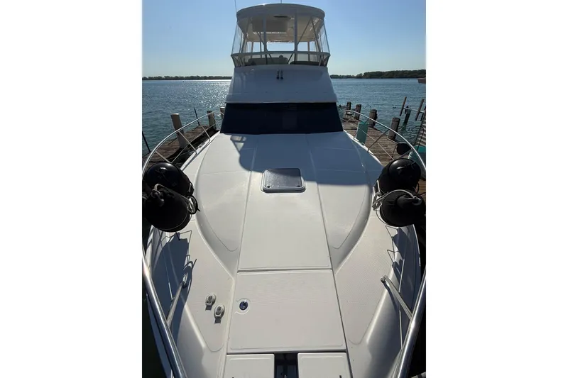 Slide: The Image of 2001 Silverton 42 Convertible yacht docked by the water on a sunny day. - 5