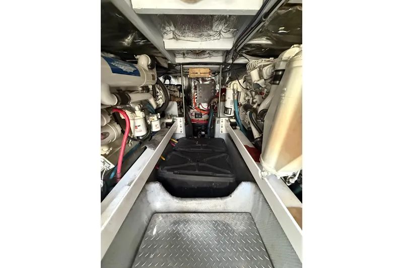 Slide: The Image of Engine room of a 2001 Silverton 42 Convertible yacht, showcasing mechanical components. - 50