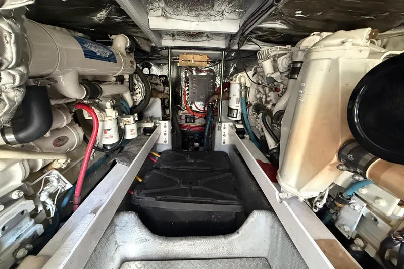 Slide: The Image of Engine room of a 2001 Silverton 42 Convertible yacht, showcasing mechanical components. - 51