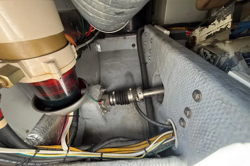 Slide: The Image of Engine compartment of a 2001 Silverton 42 Convertible boat, showing mechanical components and wiring. - 52