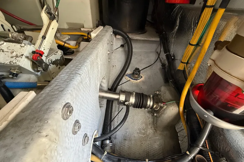 Slide: The Image of Engine compartment of a 2001 Silverton 42 Convertible boat, showing mechanical components and wiring. - 53