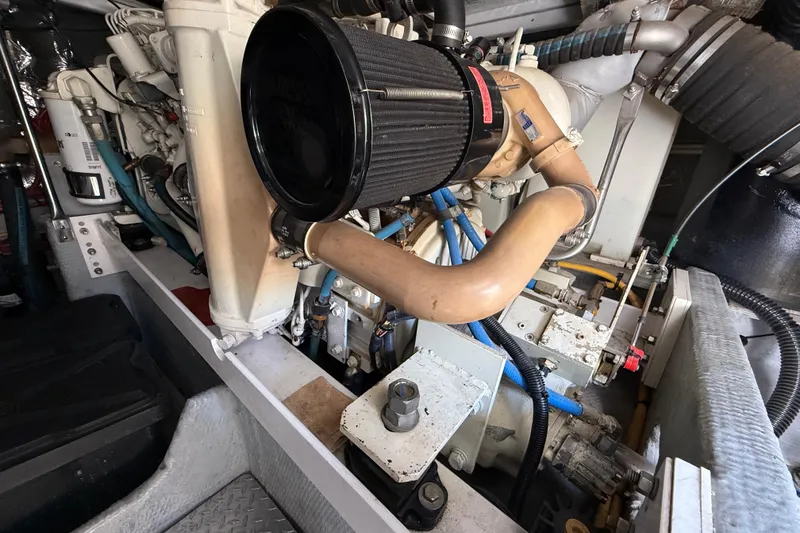 Slide: The Image of Engine compartment of a 2001 Silverton 42 Convertible boat, showcasing mechanical components. - 54