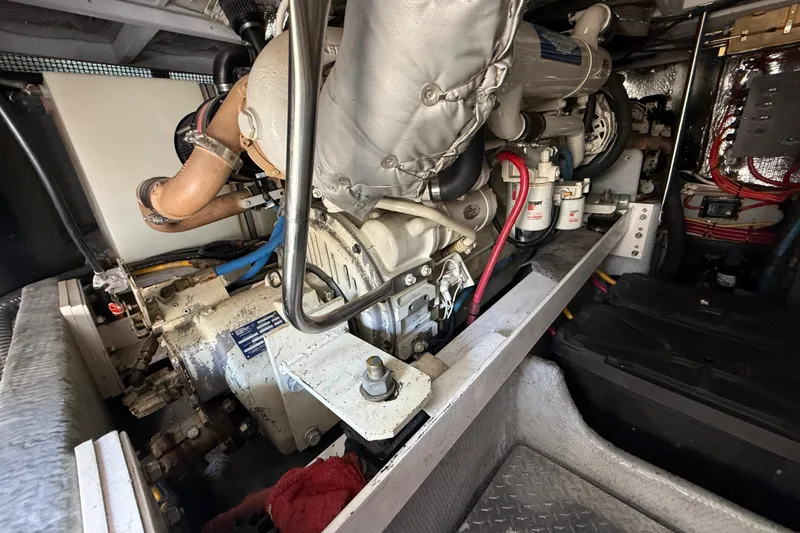 Slide: The Image of Engine room of a 2001 Silverton 42 Convertible yacht, showcasing mechanical components. - 55
