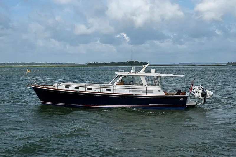 The Image of 2004 Grand Banks 49 Eastbay HX yacht cruising on open water under cloudy skies. - 0