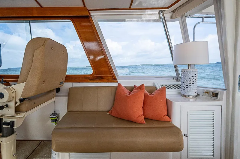 Slide: The Image of Interior of 2004 Grand Banks 49 Eastbay HX with ocean view, seating, and lamp. - 11