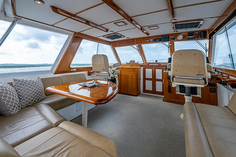 Slide: The Image of Luxurious interior of 2004 Grand Banks 49 Eastbay HX yacht with plush seating and elegant wood finishes. - 13
