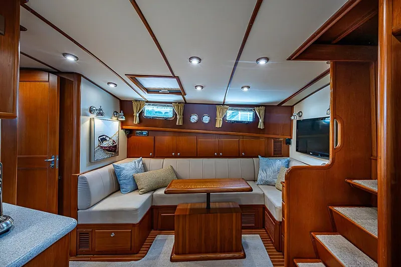 Slide: The Image of Luxurious 2004 Grand Banks 49 Eastbay HX yacht interior with elegant wood finish and cozy seating. - 16