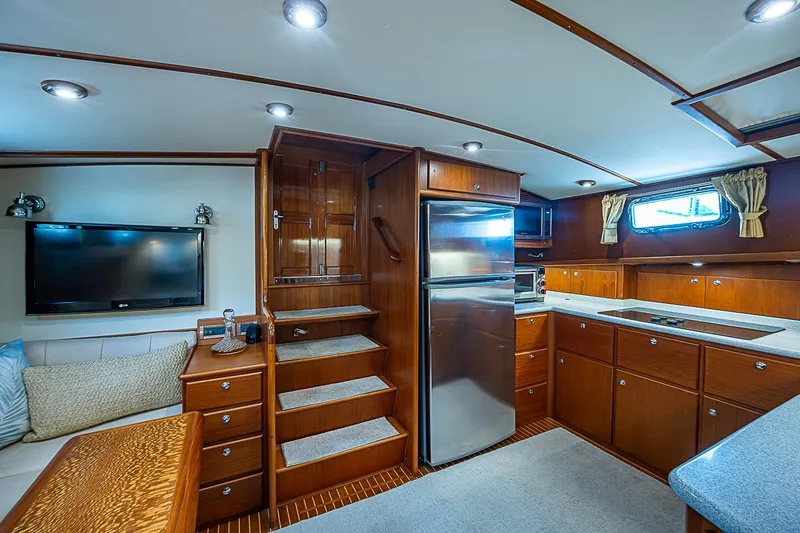Slide: The Image of Luxurious 2004 Grand Banks 49 Eastbay HX yacht interior with modern kitchen and cozy seating area. - 18