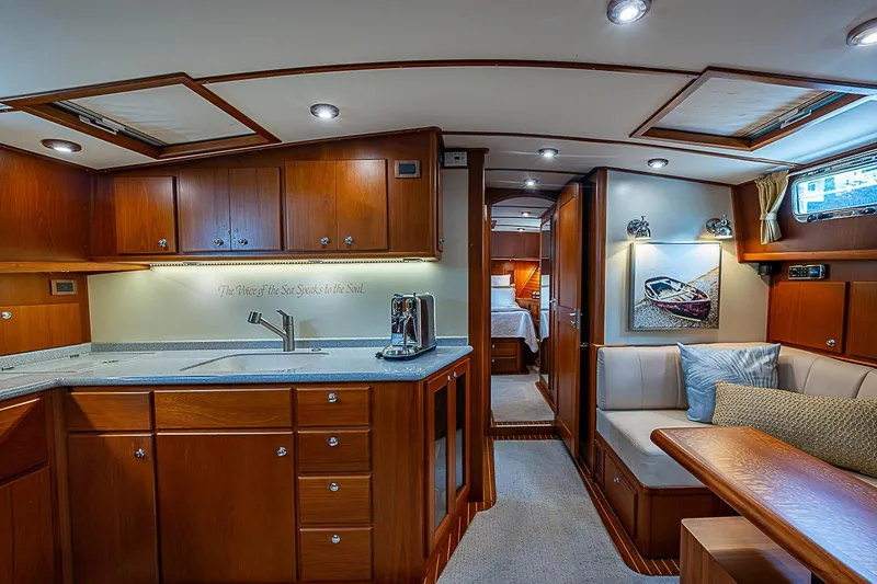 Slide: The Image of Luxurious 2004 Grand Banks 49 Eastbay HX yacht interior with elegant wood cabinetry and cozy seating. - 21