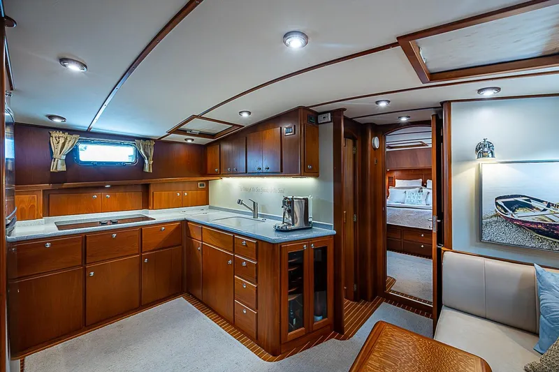 Slide: The Image of Luxurious 2004 Grand Banks 49 Eastbay HX yacht interior with elegant wood cabinetry and modern amenities. - 22