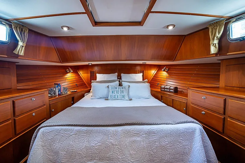 Slide: The Image of Luxurious 2004 Grand Banks 49 Eastbay HX yacht cabin with elegant wood finish and cozy bedding. - 26