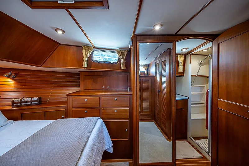 Slide: The Image of Luxurious 2004 Grand Banks 49 Eastbay HX yacht cabin with elegant wood finish and ensuite bathroom. - 27