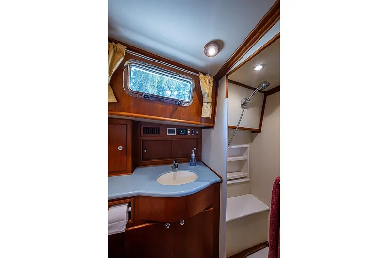 Slide: The Image of Luxurious 2004 Grand Banks 49 Eastbay HX yacht bathroom with wood accents and modern fixtures. - 28