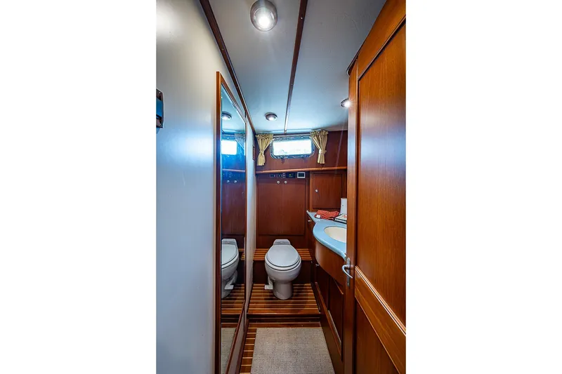 Slide: The Image of Luxurious 2004 Grand Banks 49 Eastbay HX yacht bathroom with wooden cabinetry and modern fixtures. - 30