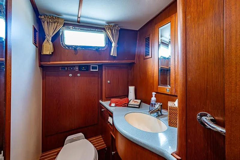 Slide: The Image of Luxurious 2004 Grand Banks 49 Eastbay HX yacht bathroom with wood paneling and modern amenities. - 31