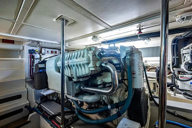 Slide: The Image of Engine room of 2004 Grand Banks 49 Eastbay HX yacht, showcasing machinery and components. - 32