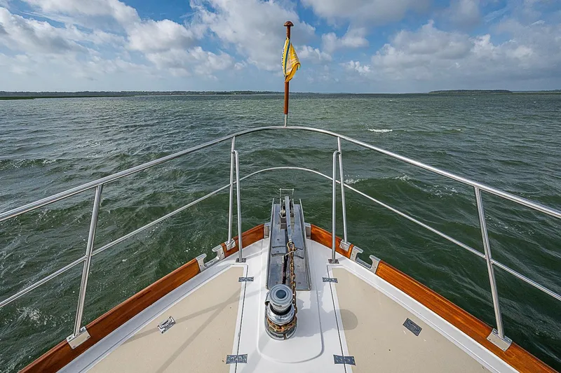 Slide: The Image of Bow view of 2004 Grand Banks 49 Eastbay HX yacht on open water. - 38