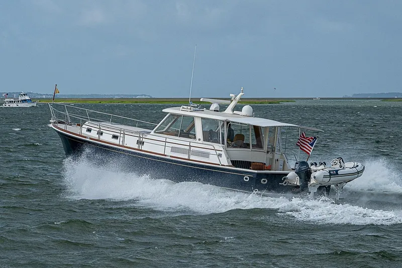 Slide: The Image of 2004 Grand Banks 49 Eastbay HX cruising on open water with American flag. - 41