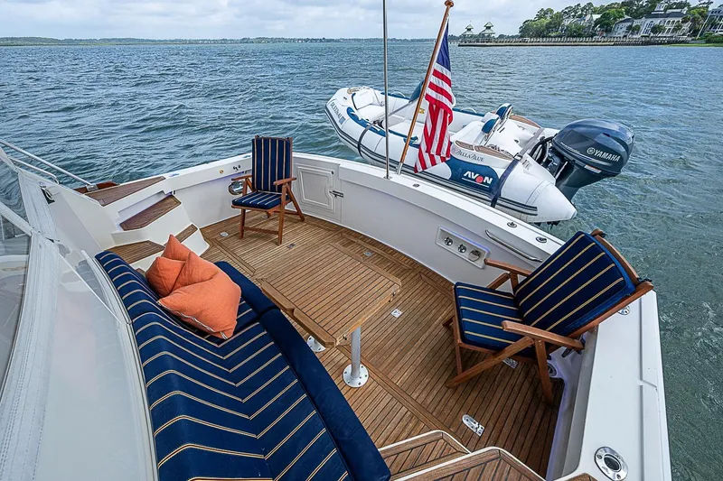 Slide: The Image of Luxurious 2004 Grand Banks 49 Eastbay HX yacht deck with seating and American flag. - 5