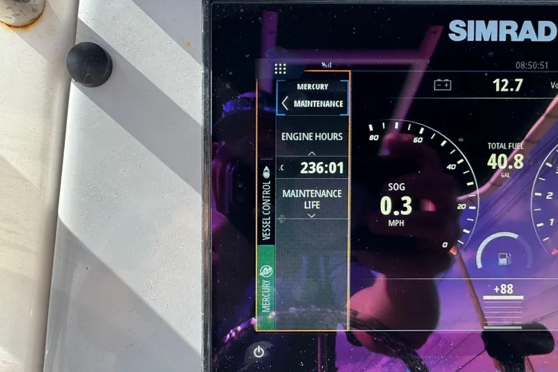 Slide: The Image of Simrad display on 2021 Trophy T22CX showing engine hours and fuel data. - 12