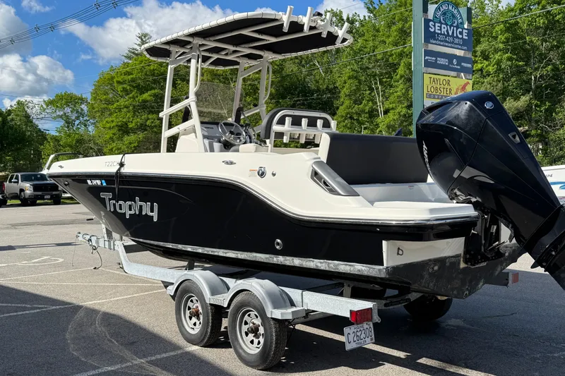 Slide: The Image of 2021 Trophy T22CX boat on trailer, parked outdoors under clear sky. - 4