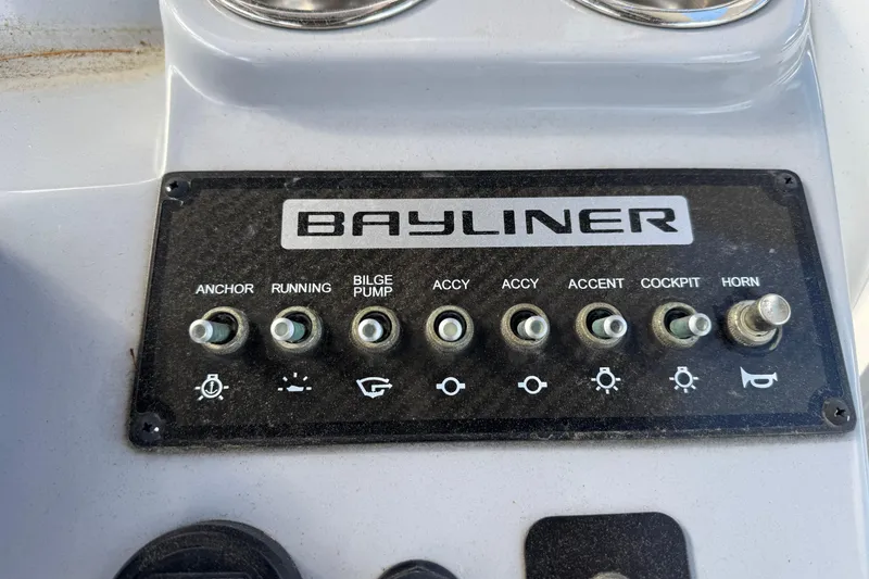 Slide: The Image of Control panel of a 2021 Trophy T22CX boat with various switches and Bayliner branding. - 8