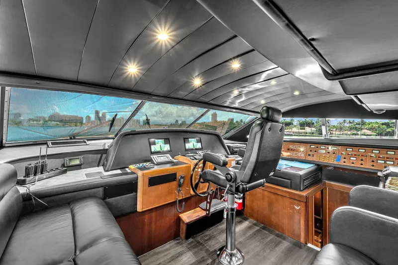 Slide: The Image of Luxurious helm of 2002 Ferretti Yachts Custom Line 94, featuring advanced navigation controls. - 54