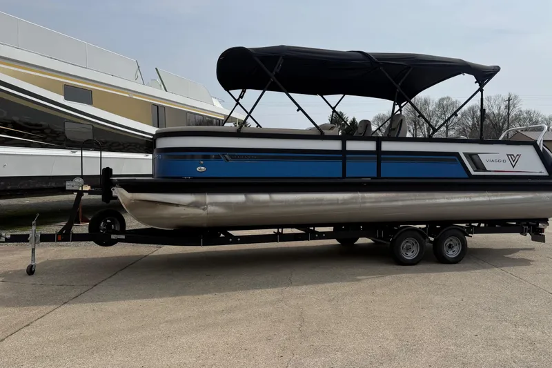 The Image of 2022 Viaggio Diamante S 26 pontoon boat on trailer, featuring blue and black design. - 1