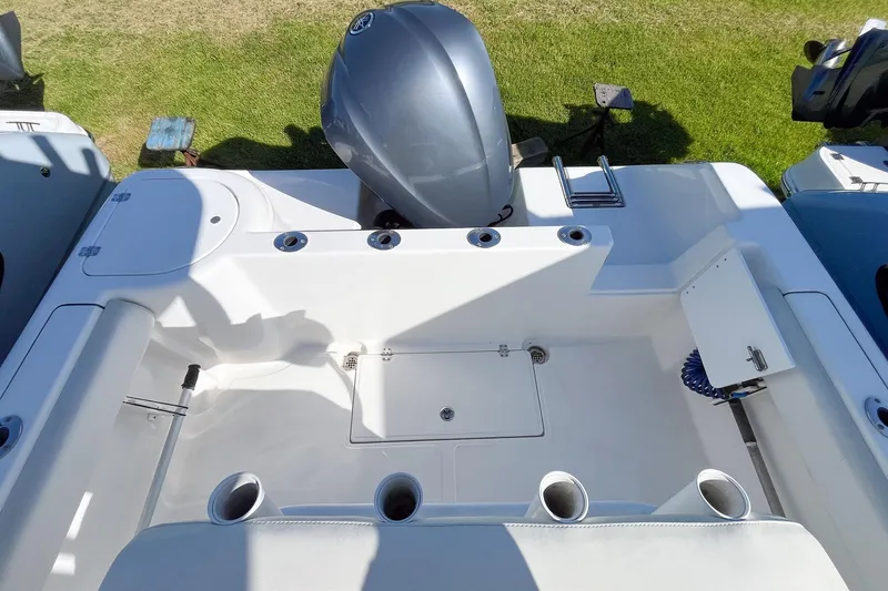 Slide: The Image of 2013 Tidewater 230 CC Adventure boat deck with motor and storage compartments. - 3