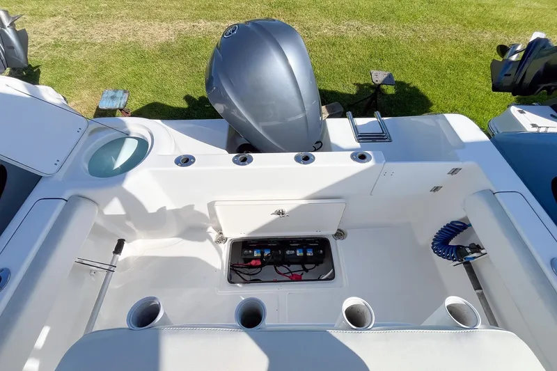 Slide: The Image of 2013 Tidewater 230 CC Adventure boat interior with motor and storage compartment. - 4