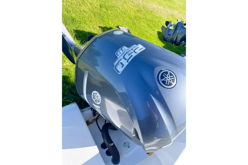 Slide: The Image of Yamaha outboard motor on 2013 Tidewater 230 CC Adventure boat, displayed on grass. - 5