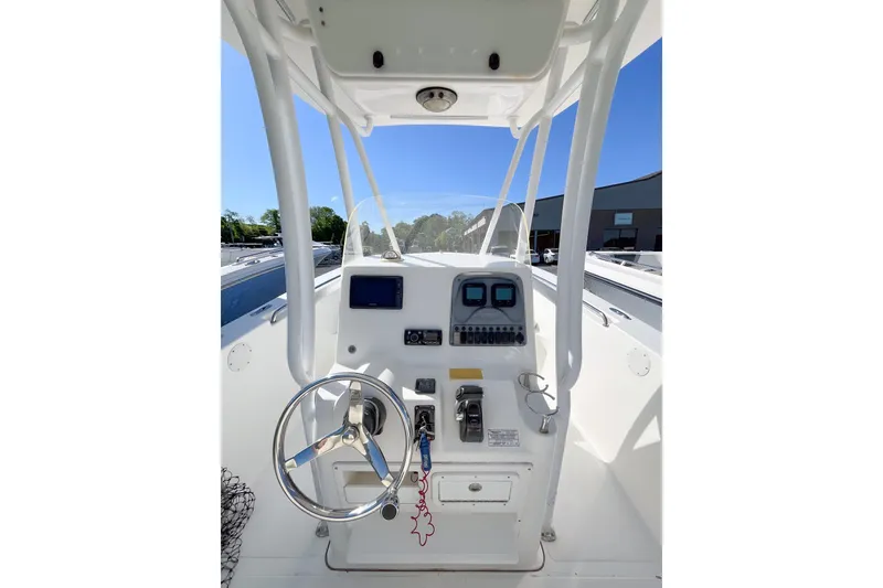 Slide: The Image of 2013 Tidewater 230 CC Adventure boat console with steering wheel and controls. - 6