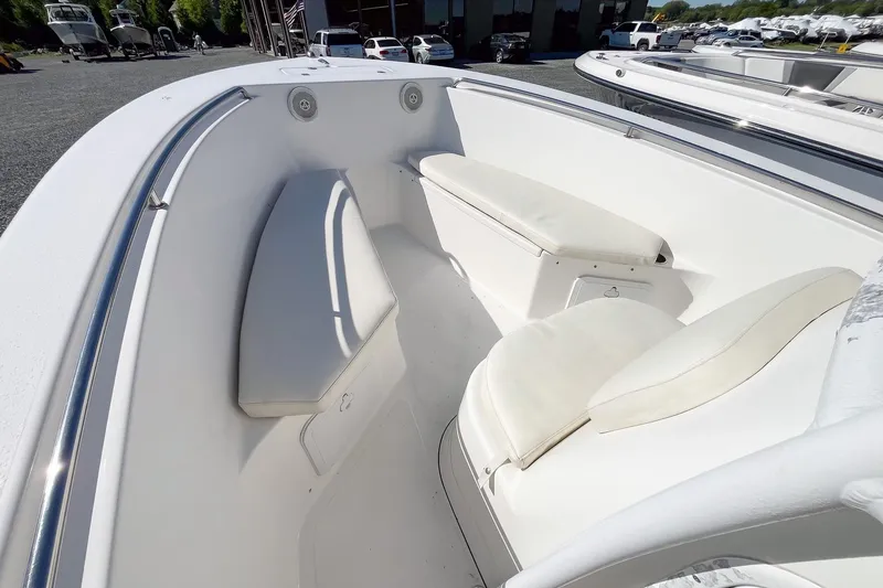 Slide: The Image of 2013 Tidewater 230 CC Adventure boat interior with white cushioned seating. - 7