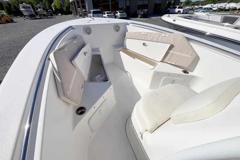 Slide: The Image of 2013 Tidewater 230 CC Adventure boat interior with open storage compartments and seating. - 8