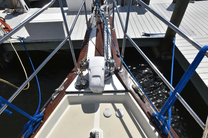 Slide: The Image of Bow view of 1995 Island Packet 37 sailboat docked, featuring anchor and deck details. - 2