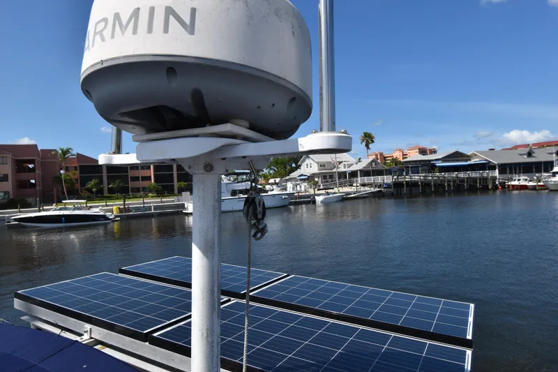 Slide: The Image of Radar and solar panels on a 1995 Island Packet 37 sailboat in a marina. - 6