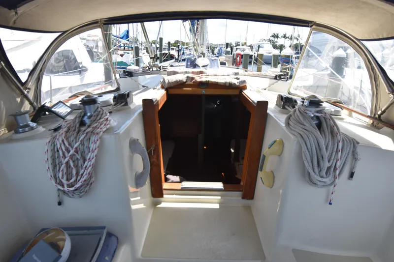 Slide: The Image of Cockpit view of a 1995 Island Packet 37 sailboat, featuring ropes and winches. - 7