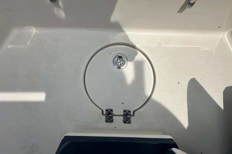 Slide: The Image of 2026 Ranger 2660 Bay boat deck with circular hatch and latch. - 10