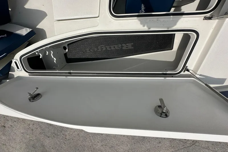 Slide: The Image of Open storage compartment on a 2026 Ranger 2660 Bay boat, showcasing interior details. - 12