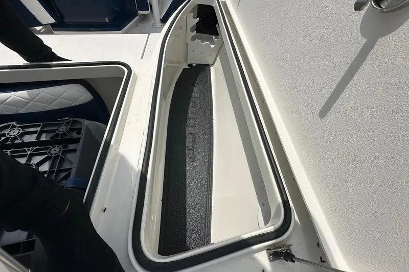 Slide: The Image of Open storage compartment on 2026 Ranger 2660 Bay boat, showcasing interior design. - 14