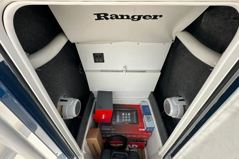 Slide: The Image of Storage compartment of 2026 Ranger 2660 Bay boat with speakers and equipment. - 17